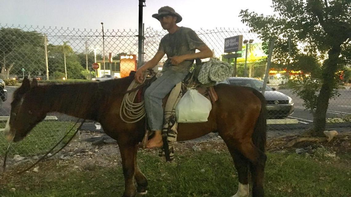 Chris Emerson on Trigger, a horse he said he rode from South Carolina to Miami. Photographed Tuesday night on a path under the Metrorail tracks near Coconut Grove, he was arrested Wednesday morning on animal-cruelty charges tied to Trigger’s health.