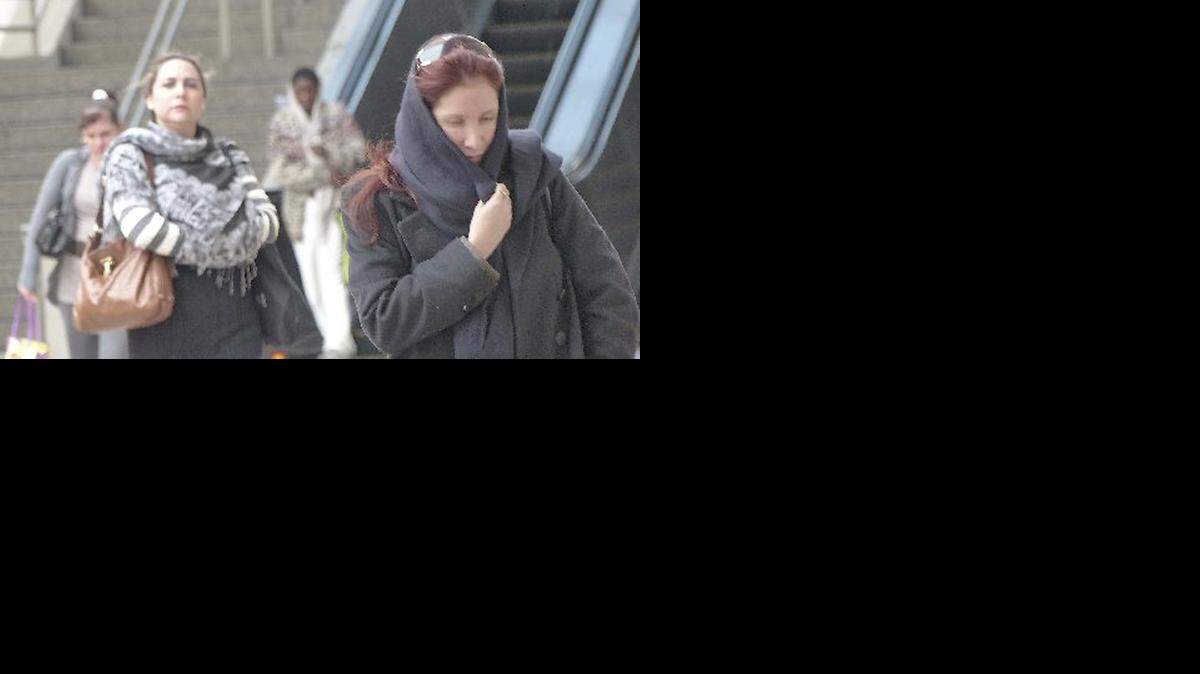 
FILE: Roanne Boekhoaut from Aruba covers up in the chilling cold weather as she walks in downtown Miami.
