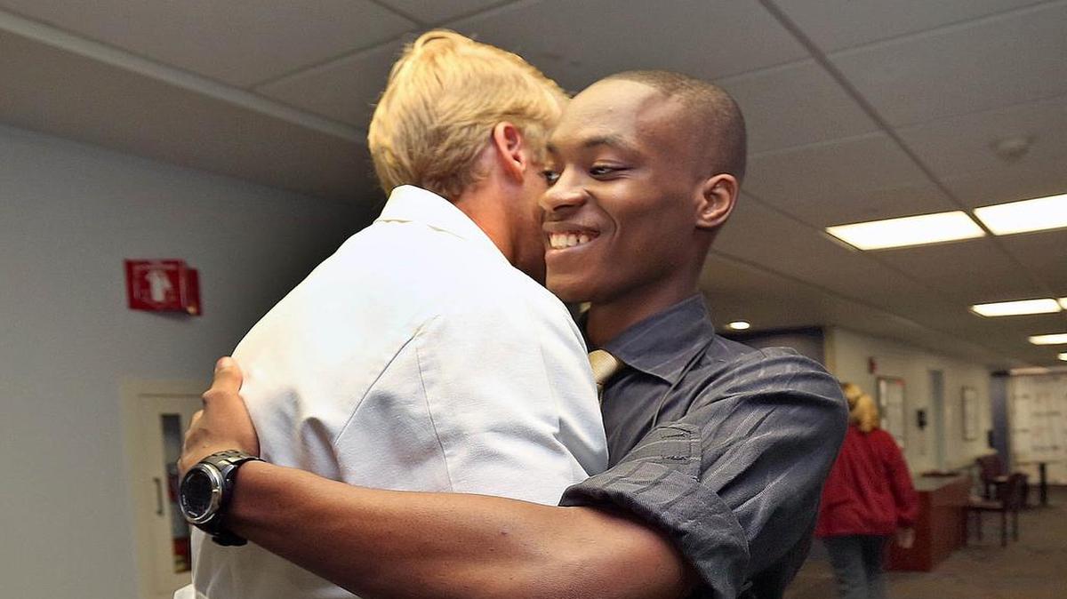 
Patient Jean Cine,19, hugs Dr. Eric Peterson as he thanks the doctor for saving his life. 
