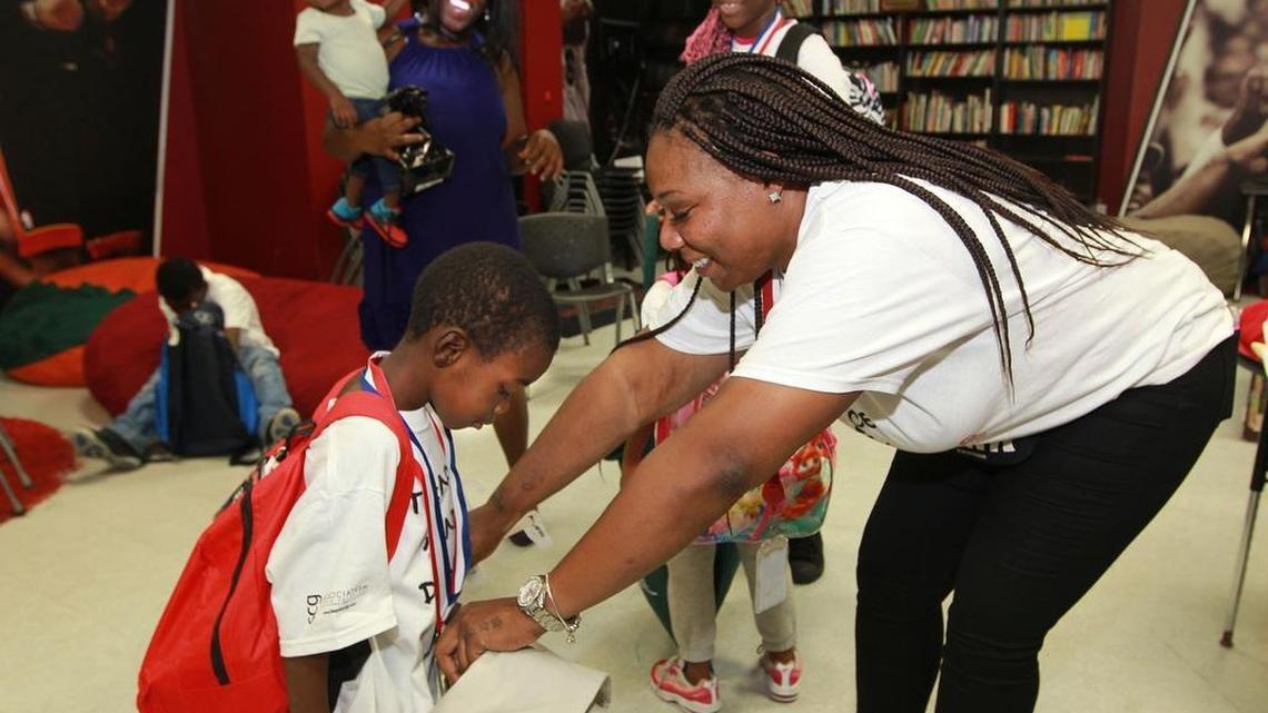 
Monifa Scott helps David with school suppiles at a back-to-school party at the Chapman partnership homeless shelters. The kids got backpacks, uniforms, notebooks, pencils and more at the giveaway on Thursday.
