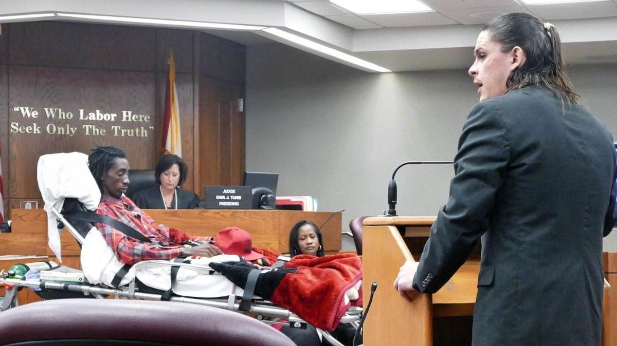 
Security guard Lukace Kendle represents himself in Miami-Dade criminal court as he cross examines Michael Smathers, the surviving victim who is now paralyzed, on Thursday, Sept. 3, 2015.
