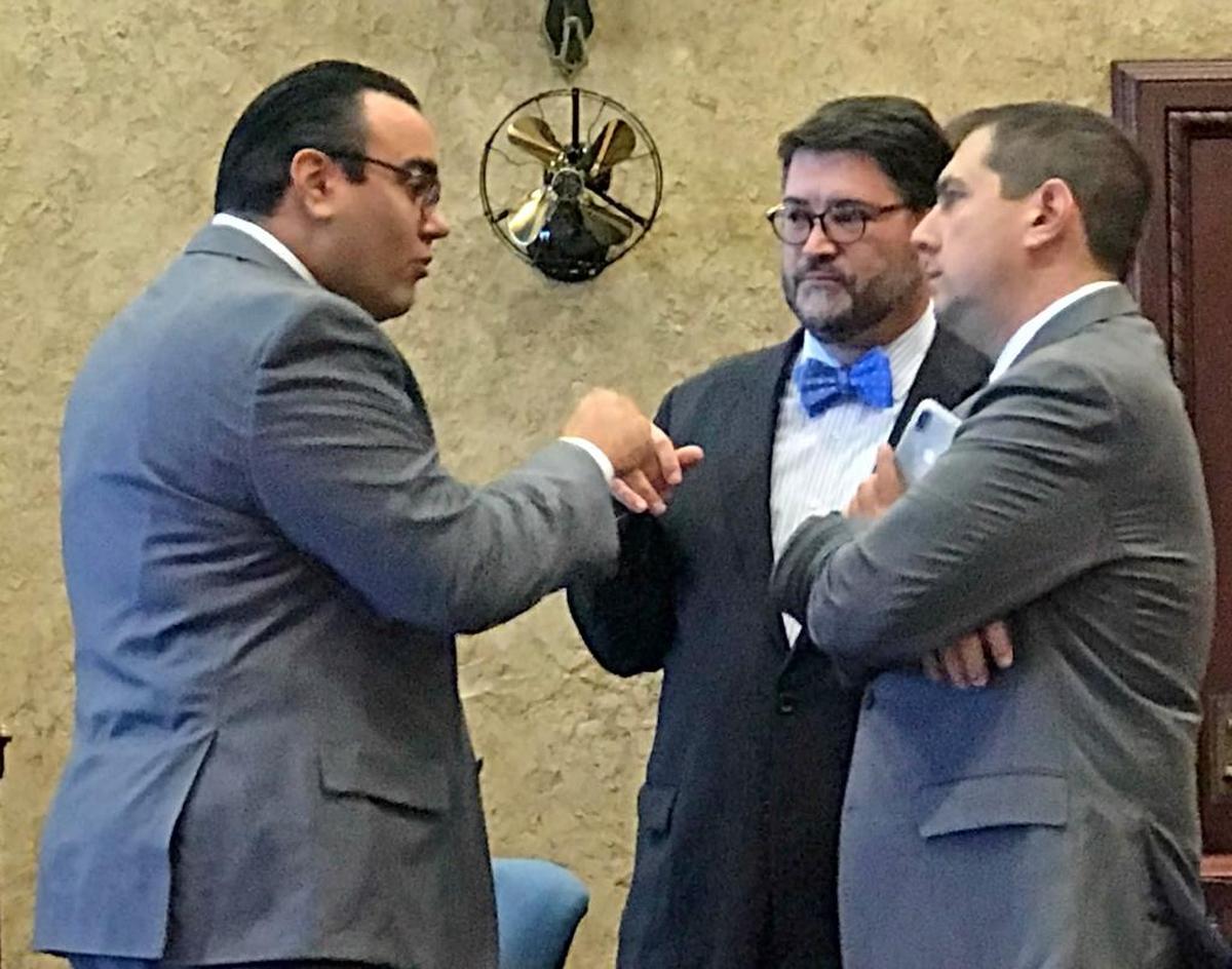 Alfonso “Alfie” Leon, left, speaks to his attorneys J.C. Planas, center, and Matthew Sarelson during a break in Friday’s trial.