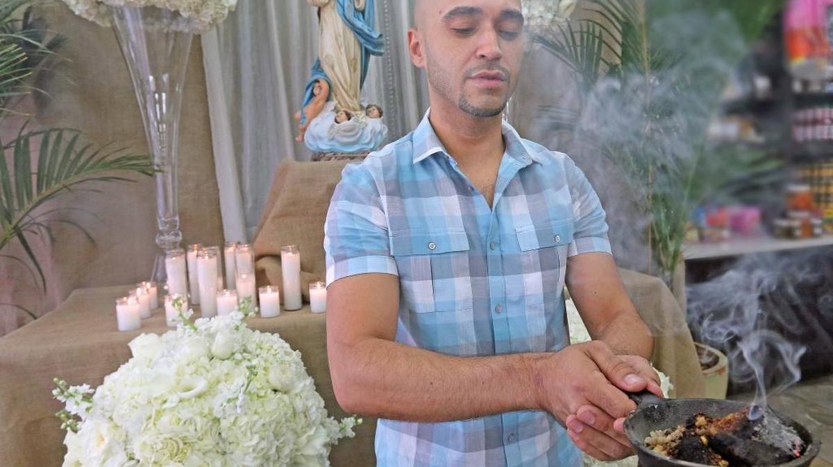 Luis Flores burns incense in front of an altar in honor of the Immaculate Conception of Mary, Nicaragua’s patron saint, for the annual La Gritería celebration.