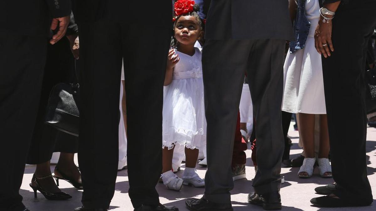 Tedrika King, 2, waits outside before the start of a funeral service for 13-year-old Teddra King on Saturday, May 6, 2017.