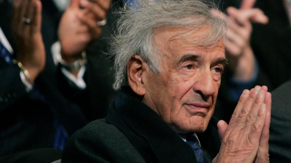 Novelist and Nobel Peace Prize recipient Elie Wiesel, puts his hands together as he receives applause after being acknowledged by President Bush, Wednesday, April 18, 2007, at a U.S. Holocaust Museum in Washington.