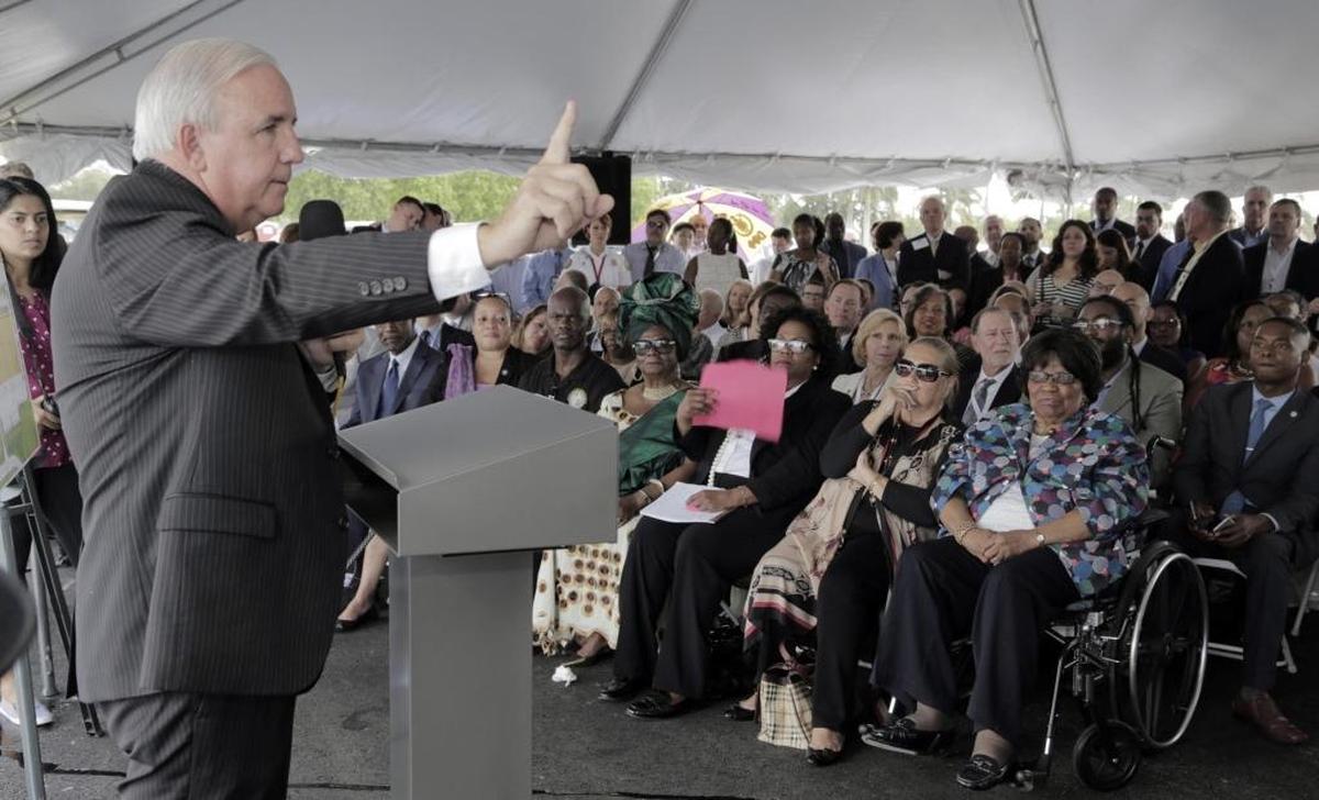 Miami-Dade County Mayor Carlos Gimenez (left) speaks to guests gathered at the groundbreaking for the Carrie Meek Foundation’s new Amazon warehouse at the Opa-locka airport.