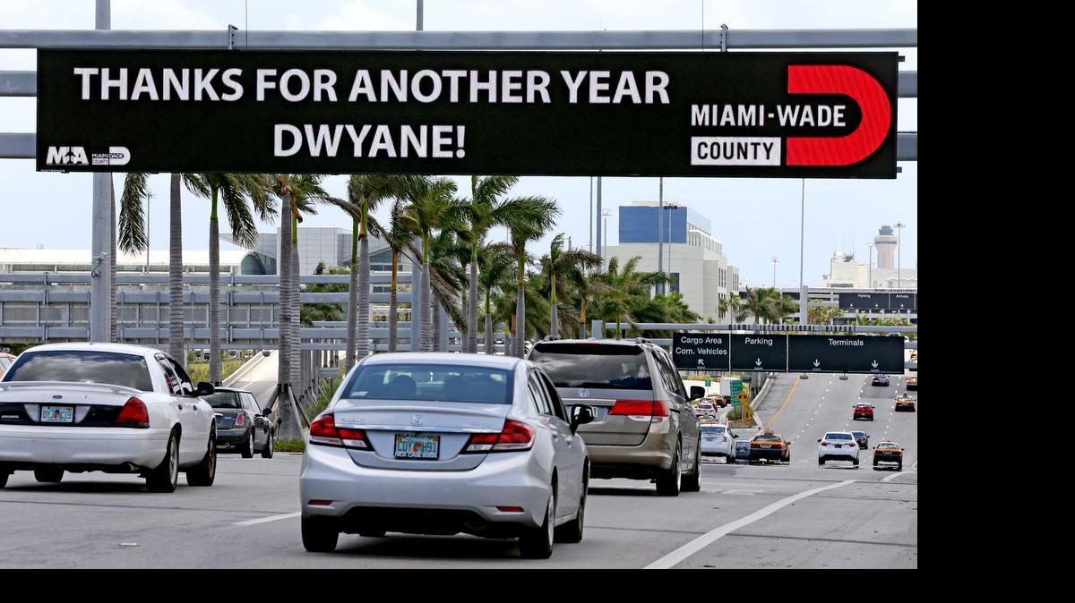 
A sign over the road at the entrance to Miami International Airport on Thursday, July 3, 2015, thanks Miami Heat's Dwyane Wade for committing to the team for another year as the team assembles it's 2015/16 team.
