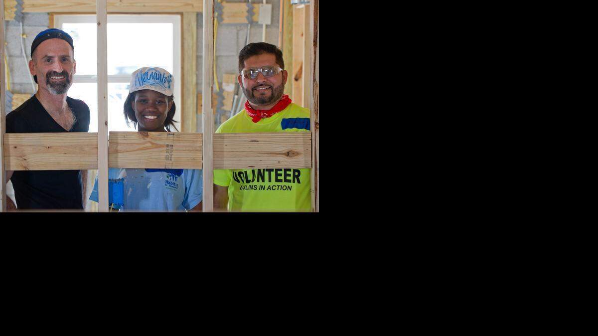 
Temple Israel’s Rabbi Tom Heyn, left, homeowner Vernante Thélusma and Abdulrauf Khan, with the Islamic Circle of North America Relief, work on Thélusma's home-in-the-making in South Miami Heights on Monday. About three dozen volunteers from a variety of faiths turned out to help build the house as part of the second annual Habitat Interfaith Build Day. 
