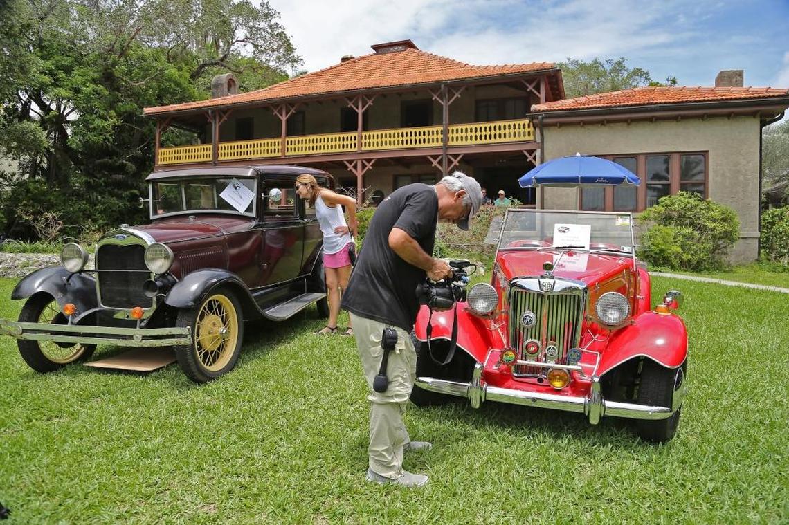 Theresa Renauld, left, gets a close look at the Ford Model A as cameraman Luis Fernandez captures video of the replica 1983 FiberFab Migi II. The Barnacle Historic State Park held its Father’s Day celebration called “Cars and Cigars” on Sunday, June 18, 2017.