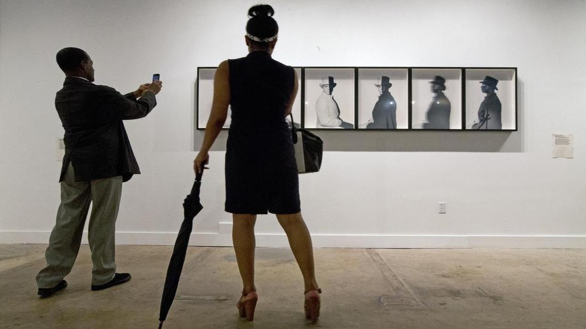 Patrons view an installation titled Zero Hour by artist Hank Willis Thomas on display during the fourth annual Art of Transformation Exhibit in Opa-locka in 2015. Planners of a new museum featuring contemporary art of the African Diaspora hope to feature artists like Thomas and others in a facility in Northwest Miami-Dade.