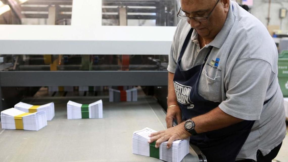 An employee prepares ballots for the Nov. 8 election at Miami-Dade County’s Internal Services print shop on Friday.