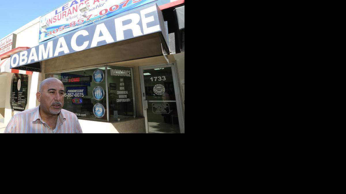 
Michael Khoury, owner of Leading Insurance Agency in Miami, offers assistance signing consumers up for health coverage under the Affordable Care Act on Feb. 15 — the last day of 2015 open enrollment.

