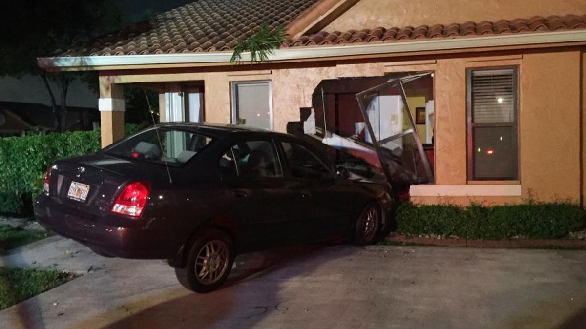 An 80-year-old driver was injured when they drove their car into an unoccupied house Saturday evening.