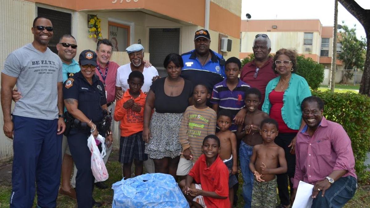 Residents and Community Redevelopment Agency members pose with South Miami Police Sgt. Henry Guzman, second from left, Officer Melvris Lopez, Chief Rene Landa, Officer Marcus Kinlaw, center, Levy Kelly and James McCants, far right, both of the CRA.