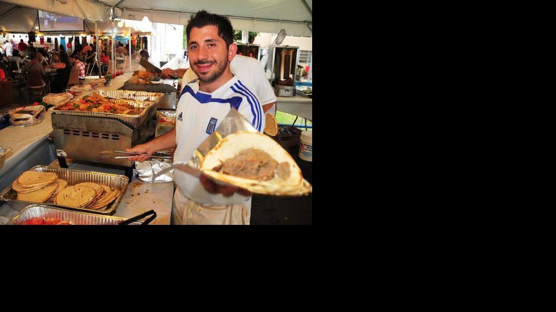 
Parishioner Alex Karavias serves up gyro at the Greek Festival held at St. Sophia Greek Orthodox Cathedral this past February.
