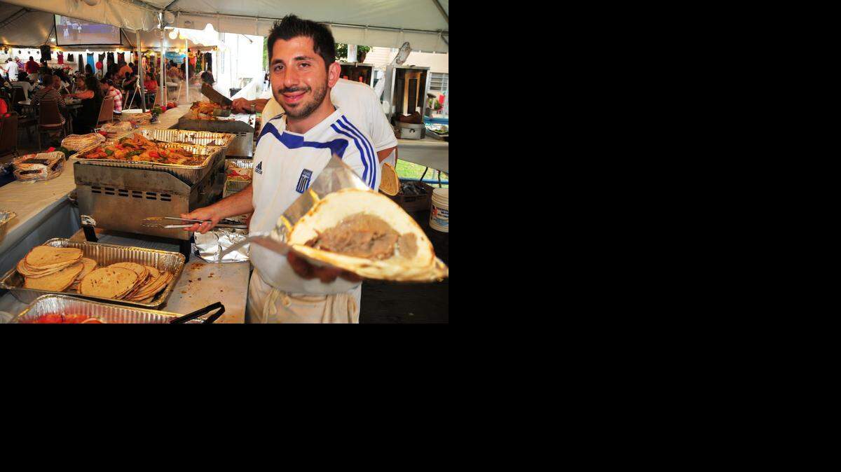 
Parishioner Alex Karavias serves up gyro at the Greek Festival held at St. Sophia Greek Orthodox Cathedral this past February.
