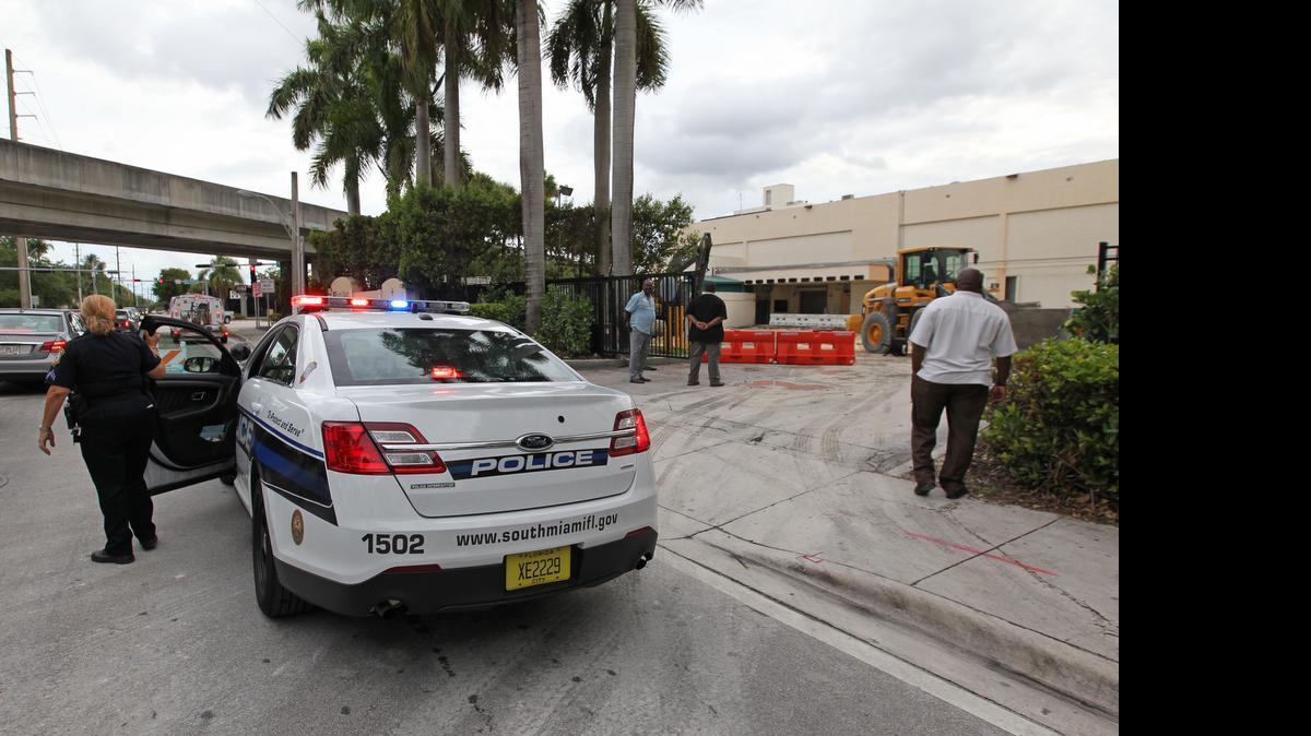 
South Miami Police stop traffic on Southwest 62nd Avenue after a gas line broke during construction at South Miami Hospital on Tuesday, May 5, 2015. The hospital had to evacuate the first floor. divert ambulances to other hospitals and close off its premises to visitors.
