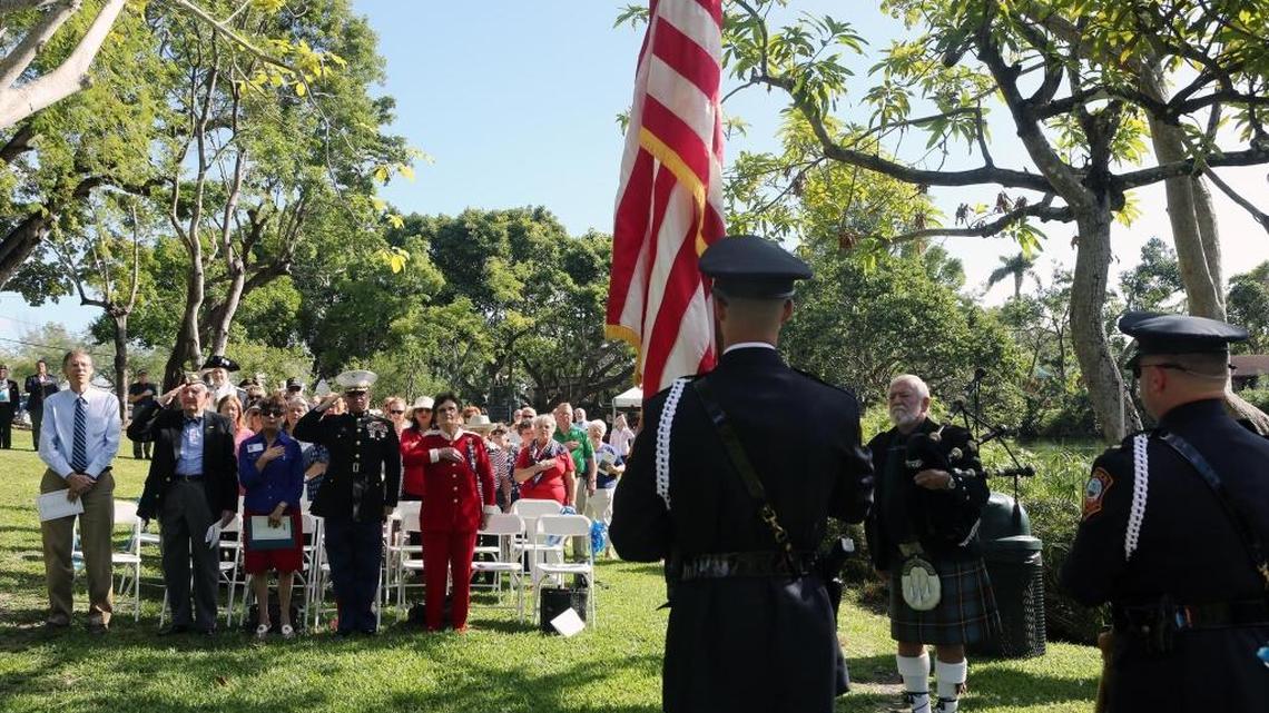 Attendees watch the Color Guard during the dedication of the Blue Star Memorial Marker at Fuchs Park in South Miami on Tuesday, Dec. 5, 2017. The city of South Miami and the South Miami Garden Club dedicated the Blue Star Memorial Highway Marker as a tribute to the Armed Forces.