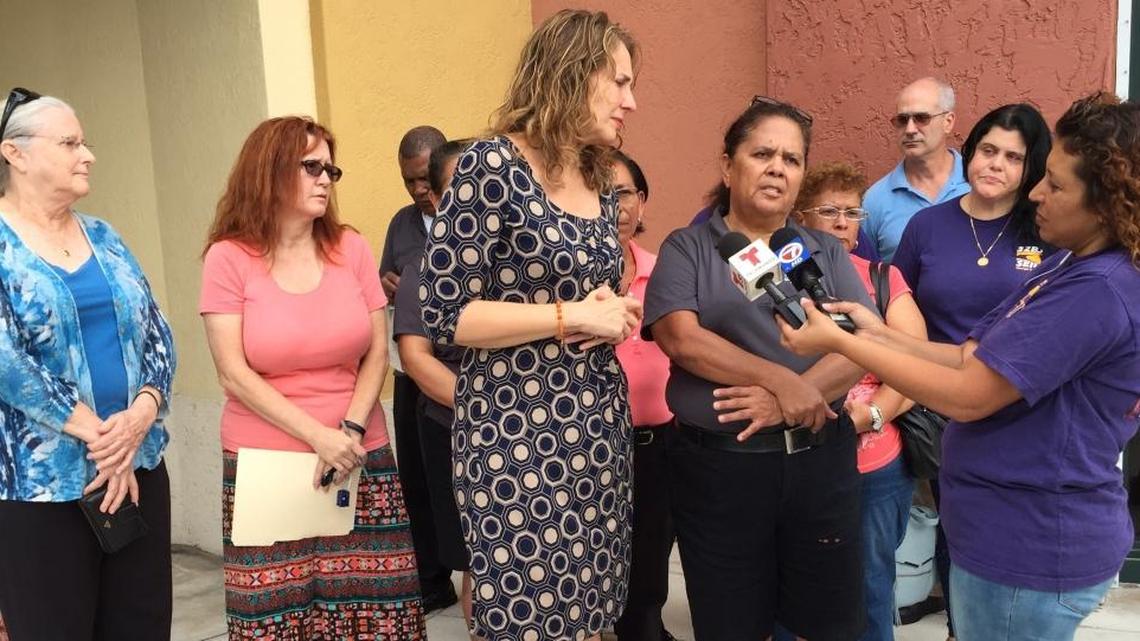
Maria Solis, with fellow Sunset Place cleaning staff members, speaks at a news conference on Tuesday at Sunset Place. To her left is Ana Tinsly, communications specialist for Union SEIU Local 32BJ.
