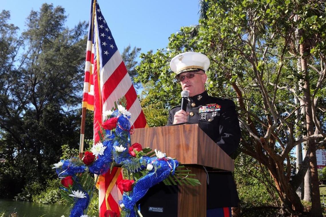 USMC Col. Michael Farrell, chief of staff at U.S. Marine Corps Forces, South and keynote speaker, salutes the flag during the dedication of the Blue Star Memorial Marker at Fuchs Park in South Miami on Tuesday, Dec. 5, 2017.