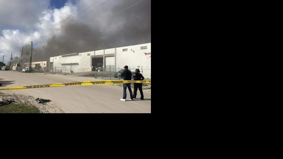 
A major warehouse send smoke into the air amid concern about the roof’s stability. 
