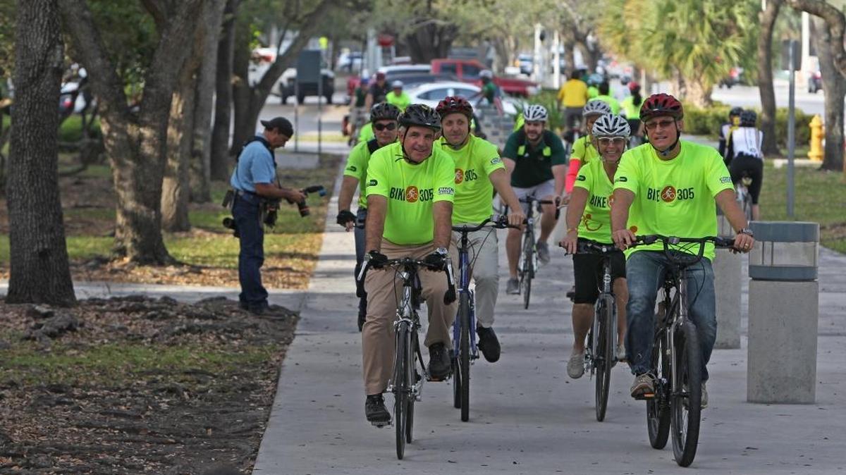 Miami-Dade County Mayor Carlos A. Gimenez, and (right front) Miami-Dade Parks Director Jack Kardys kick-off the 2016 Miami Bike-to-Work Day ride at the University of Miami Metrorail Station in March.