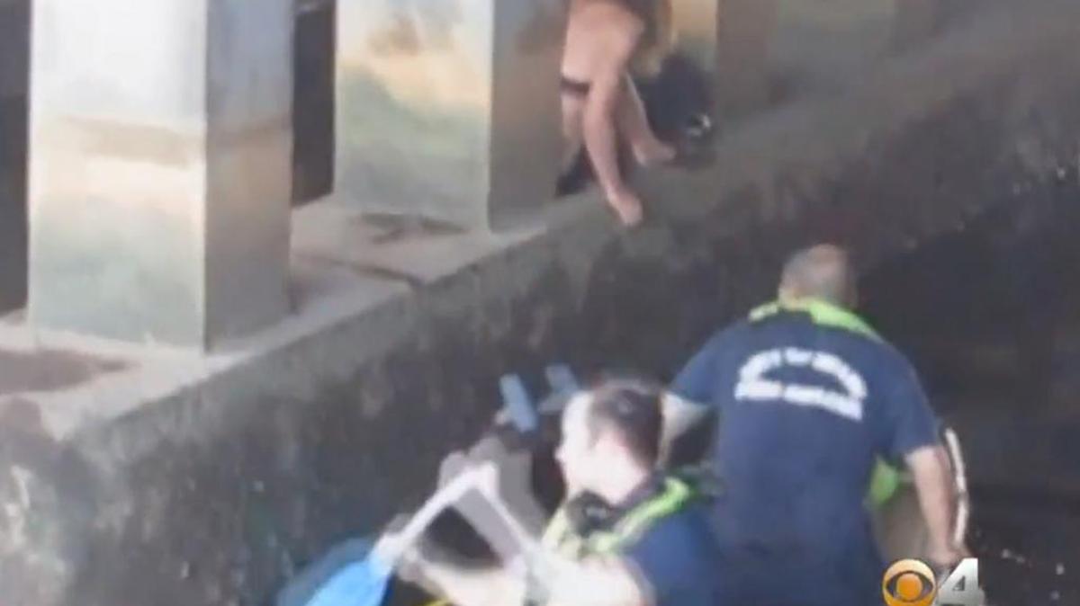 
Miami Fire Rescue crews had to pluck a woman from a canal after she fell from a bridge pillar at Northeast 79th Street and Fourth Avenue Monday, Aug. 3, 2015.
