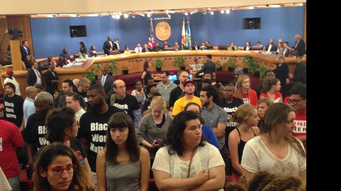 
Protesters of the Miami Worldcenter project rise and turn their backs as developer Nitin Motwani prepares to address Miami-Dade commissioners over a special taxing district for the mixed-use development. Those who wouldn’t sit down were ejected from the commission chambers. 
