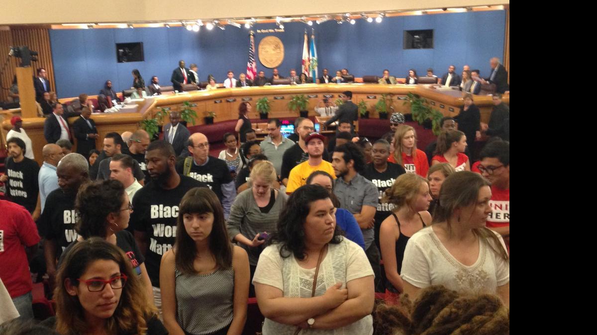 
Protesters of the Miami Worldcenter project rise and turn their backs as developer Nitin Motwani prepares to address Miami-Dade commissioners over a special taxing district for the mixed-use development. Those who wouldn’t sit down were ejected from the commission chambers. 
