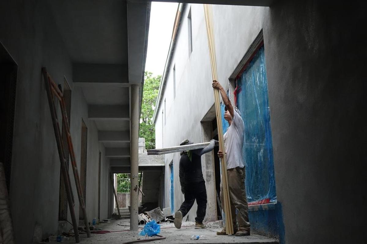Workers at the Josephine and Dunn Hotel in Overtown. Nearly three years after crews broke ground on the taxpayer-funded project, renovation of the building is nowhere near done.