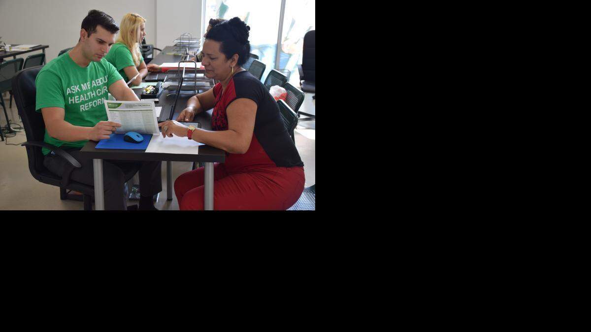 
 In one of Westland Mall’s two Sunshine Life & Health Adviser’s offices, enrollment counselor Daryll Garcia, 27, helps 49-year-old Yuritza Fons sign up for Obamacare for the first time. The 33012 ZIP code in which the agency is located ranked first in the nation for most Obamacare enrollments. 
