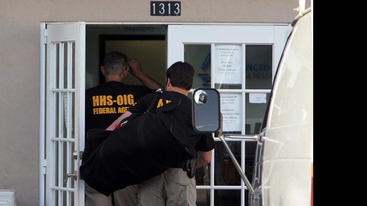 
Federal agents enter Palmetto Comprehensive Healthcare, at 1313 SW First Street in Miami, as part of a major Medicare fraud bust on Thursday.
