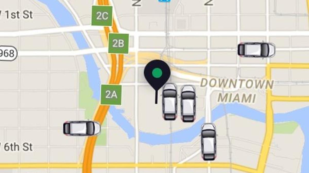 A screenshot of the Uber app, showing cars available in downtown Miami.
