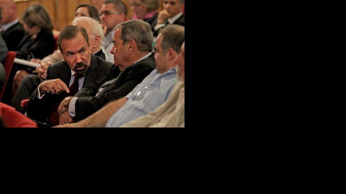 
Jorge Pérez chats with Adolfo Henriques as the Miami-Dade County Commission holds its second and final budget hearing.
