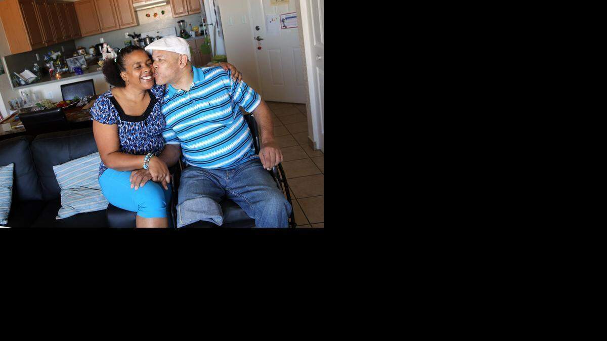 
Maricela Castillo gets a kiss on the cheek from her boyfriend, Angel Rodriguez inside of the apartment they share at Villa Aurora, ,a Carrfour Supportive Housing center. In 2010, Castillo and Angel Rodriguez met at a homeless shelter. After losing touch for a few years, the two reconnected at Carrfour Supportive Housing, a housing developer that provides supportive services to formerly homeless families. The two are now living in an apartment together and are able to care for each other.
