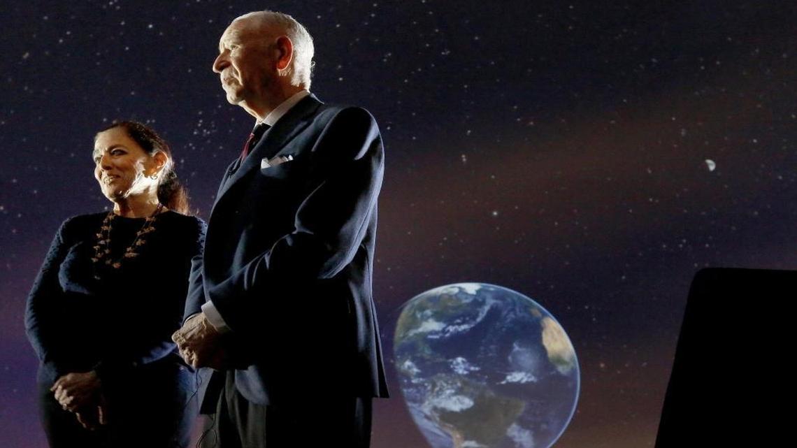 Patricia, left, and Phillip Frost, right, are interviewed inside the Planetarium at the Frost Museum of Science which bears their names.