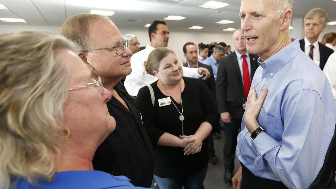Florida Gov. Rick Scott, right, speaks to attendees after a news conference, Wednesday, May 3, 2017, in Sunrise.