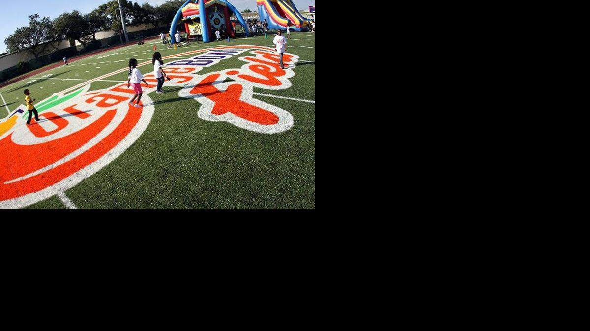 
Children play at a removated field at Miami’s Moore Park in 2011.
