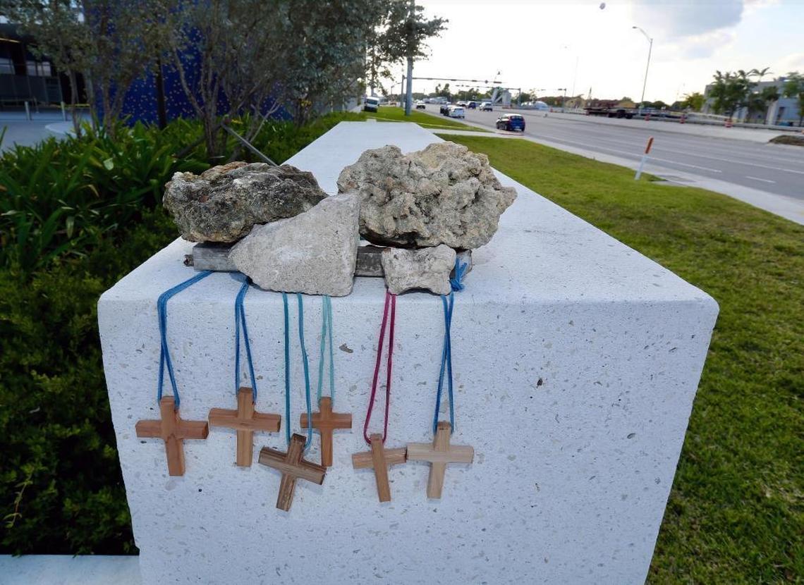 Six crosses are being held up by rubble from the pedestrian bridge that collapsed at Florida International University as a memorial to the victims.