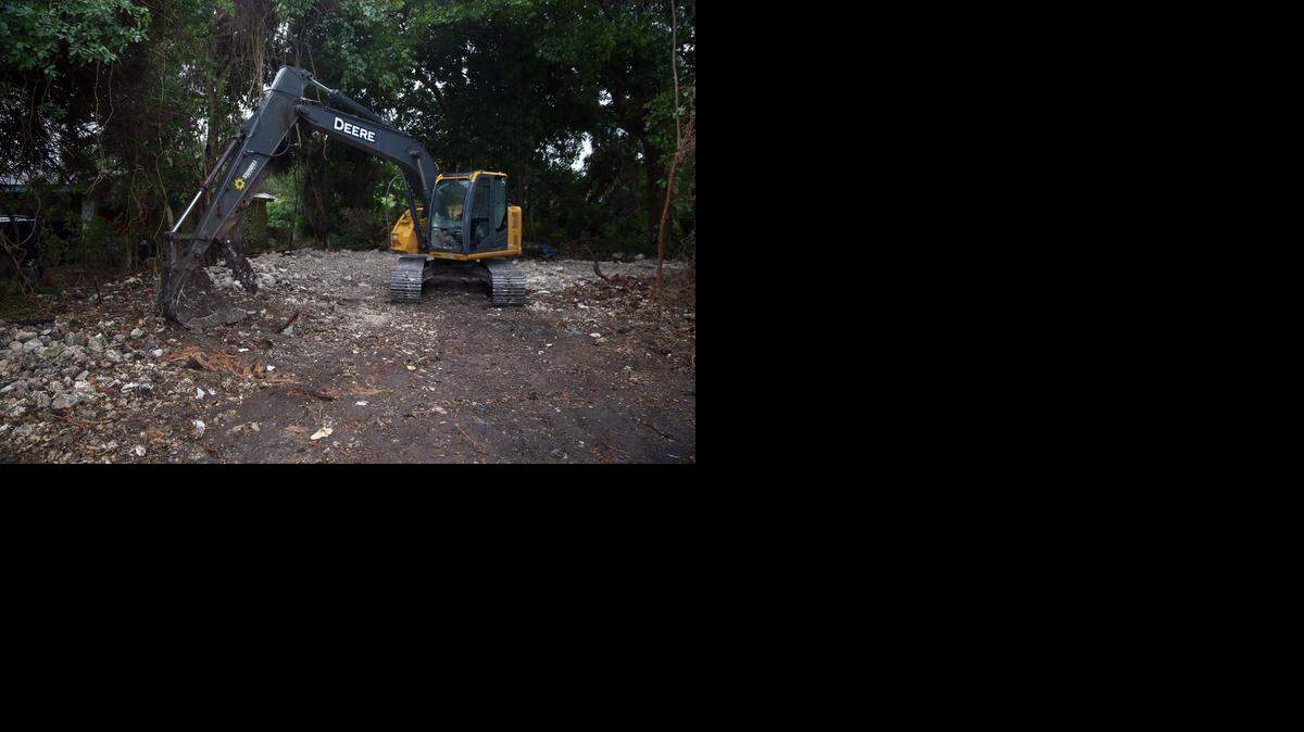 
Demolition equipment stands in front of what used to be the Harry Troeger House, a historic wood and coral rock cabin Palmetto Bay that a developer tore down despite efforts to protect the home. 


