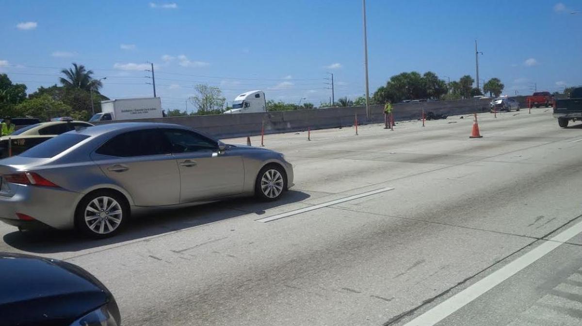 Troopers block lanes after a motorcyclist died in a crash on I95 near NW 103rd Street.