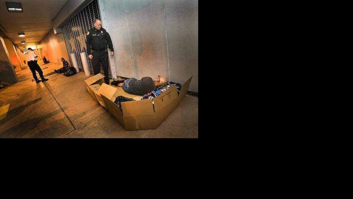 
Miami Police officer James Bernat, the department’s Homeless Coordinator, asks a homeless man in downtown Miami on Tuesday, February 17, 2015, if he would like to move to a shelter as Miami’s police outreach team works with the homeless by offering shelter in the Mat Program. 
