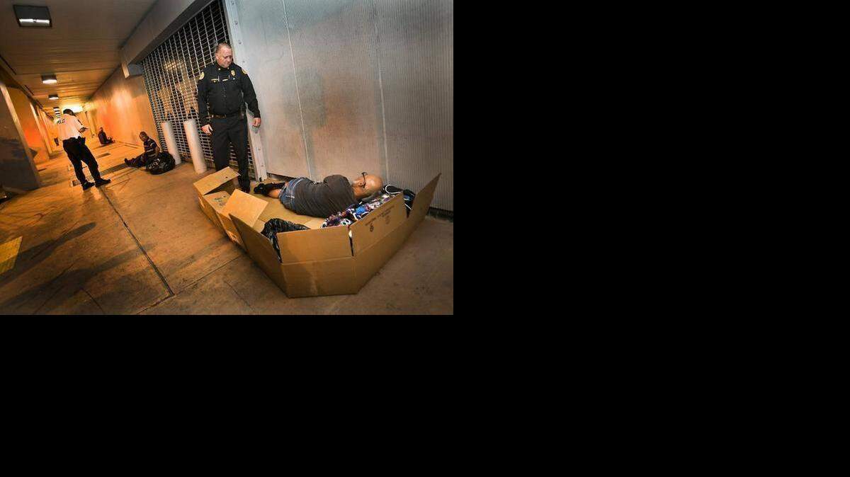 
Miami Police officer James Bernat, the department’s Homeless Coordinator, asks a homeless man in downtown Miami on Tuesday, February 17, 2015, if he would like to move to a shelter as Miami’s police outreach team works with the homeless by offering shelter in the Mat Program. 
