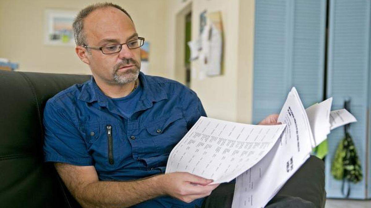 
Tony Smith, who is trying to figure out if he’ll be able to afford the HIV medication he depends on once he joins the ACA exchange, sorts through insurance papers at his home in Coral Springs on Wednesday, Oct. 22, 2014.
