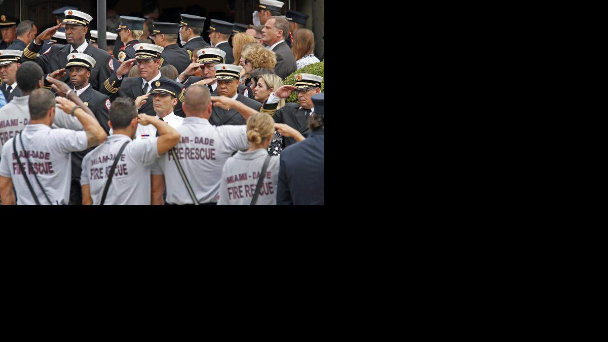 
A funeral service is held for firefighter Rafael Garcia at St. Kevin Roman Catholic Church on Thursday, March 26, 2015. Garcia died Tuesday just days after doctors discovered a tumor in his brain. His widow, Maeghan Garcia, is pregnant with a boy.
