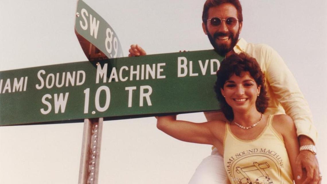 Gloria and Emilio Estefan, circa 1985, posing with Southwest 10th Terrace sign in Miami, after the street had been renamed “Miami Sound Machine Blvd.”