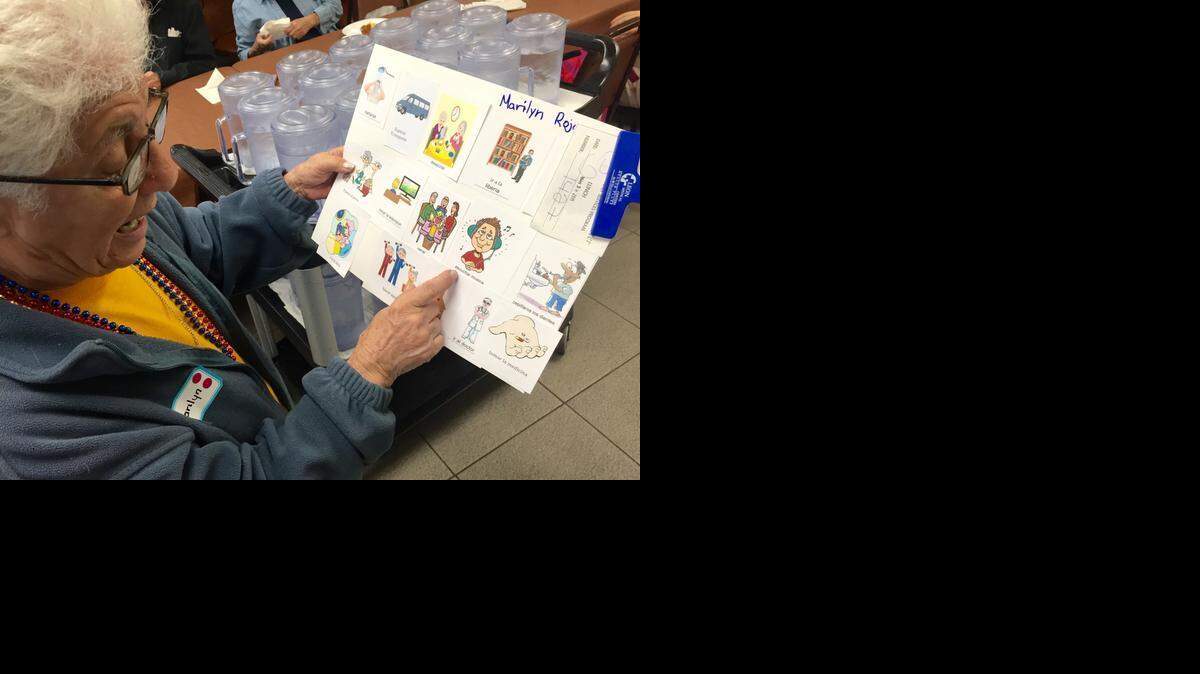 
Marilyn Rojas, 79, is showing the picture schedule she made during a memory enhancing activity with Keiser University psychology students at the Claude & Mildred Pepper Senior Center in Sweetwater on Thursday, March 26.
