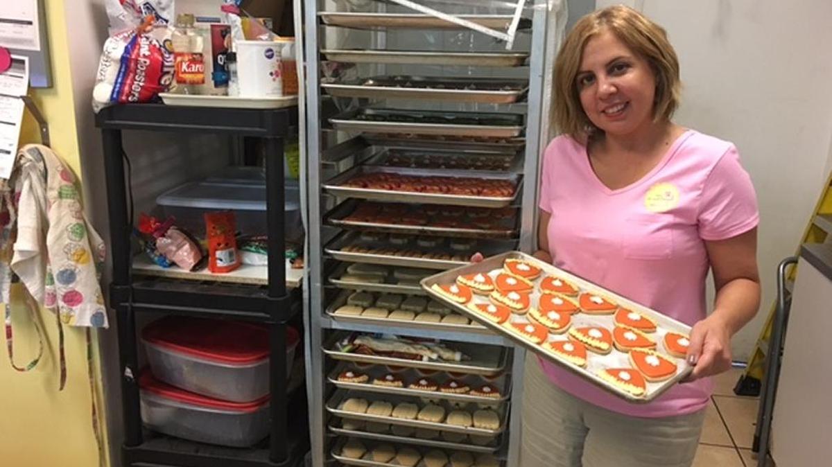 Sweet Dough owner Jeannette Martiarena shows a tray of her Thanksgiving-themed cookies.