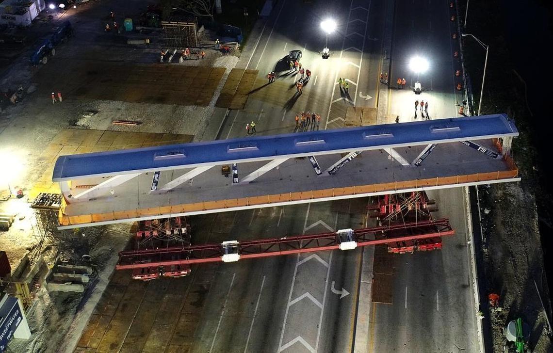 Early morning view of the main span of the FIU-Sweetwater UniversityCity Pedestrian Bridge as it was lifted from its temporary supports, rotated 90 degrees across an eight-lane thoroughfare and lowered into its permanent position over Southwest Eighth Street on Saturday, March 10, 2018.
