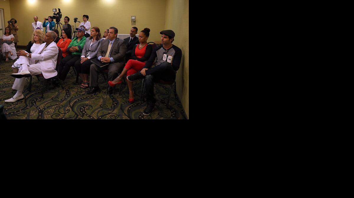 
Santeria followers listen as religious leaders, or babalawos, present ‘la letra,’ or letter — a set of predictions and advice guiding worshipers for the new year, at the Ramada Hotel in Hialeah on Friday, Jan. 2, 2015.
